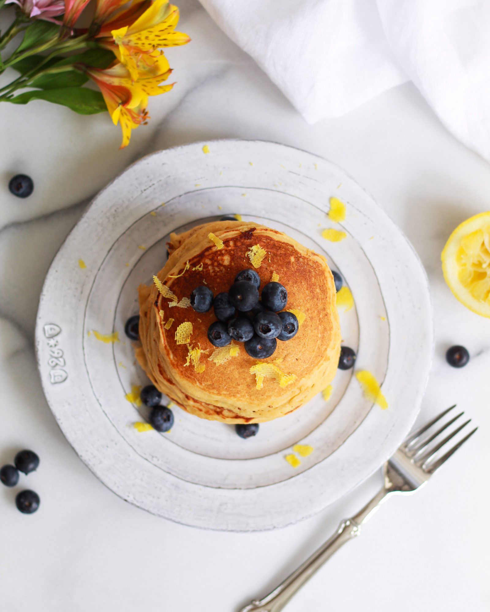 overhead shot of pancakes topped with blueberries
