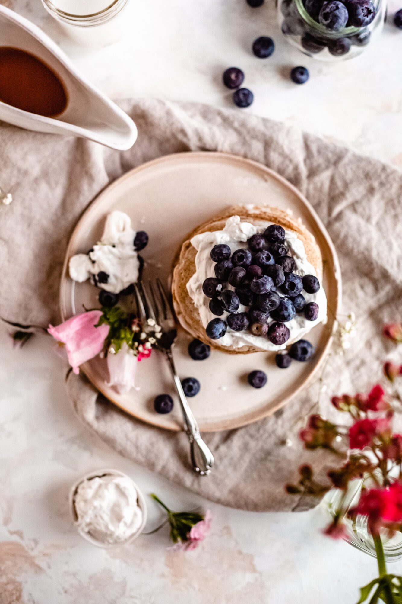overhead of pancake stack on a plate with flower