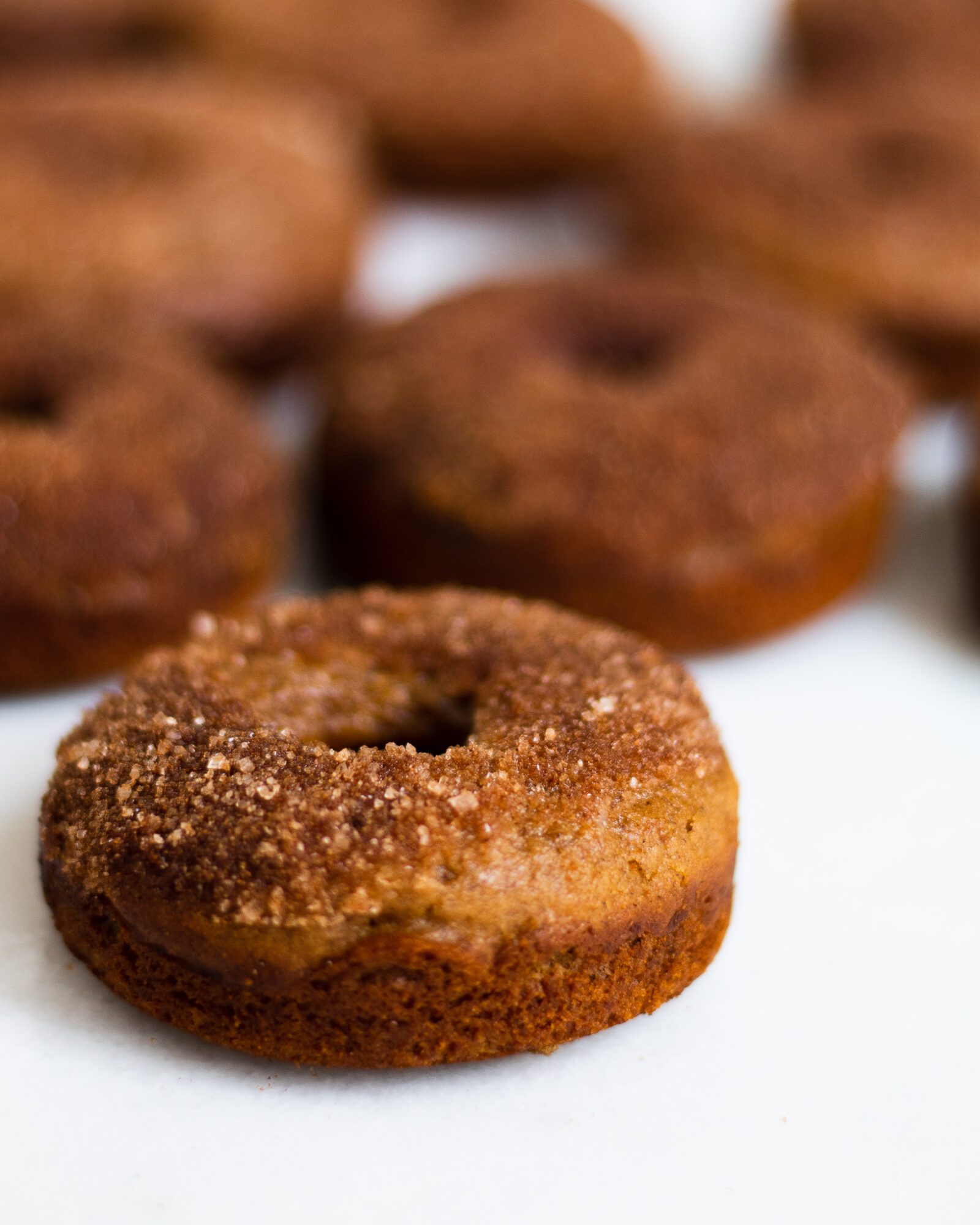 baked cinnamon sugar donuts on marble slab
