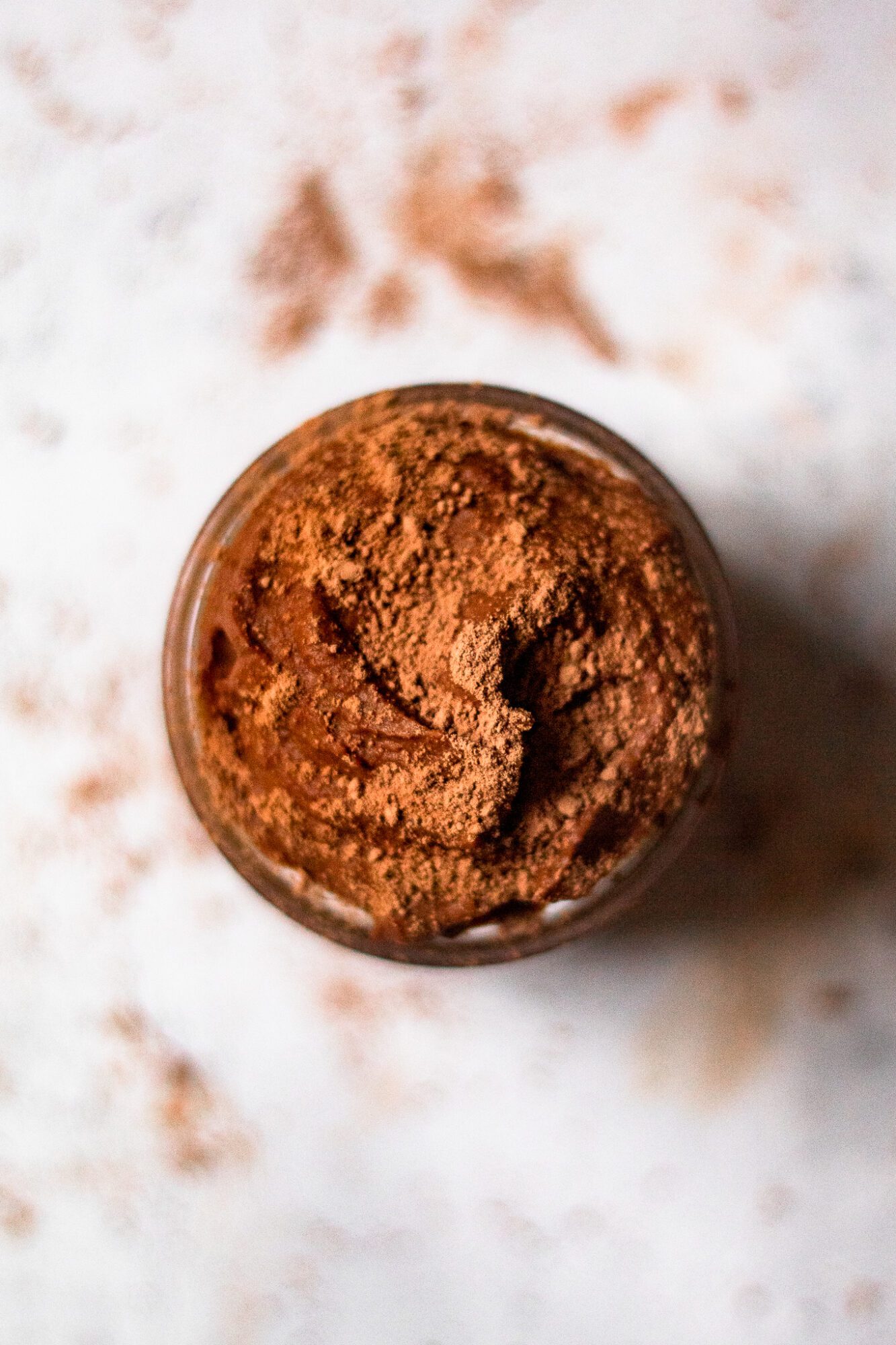 overhead of healthy chocolate mouse dusted with cacao