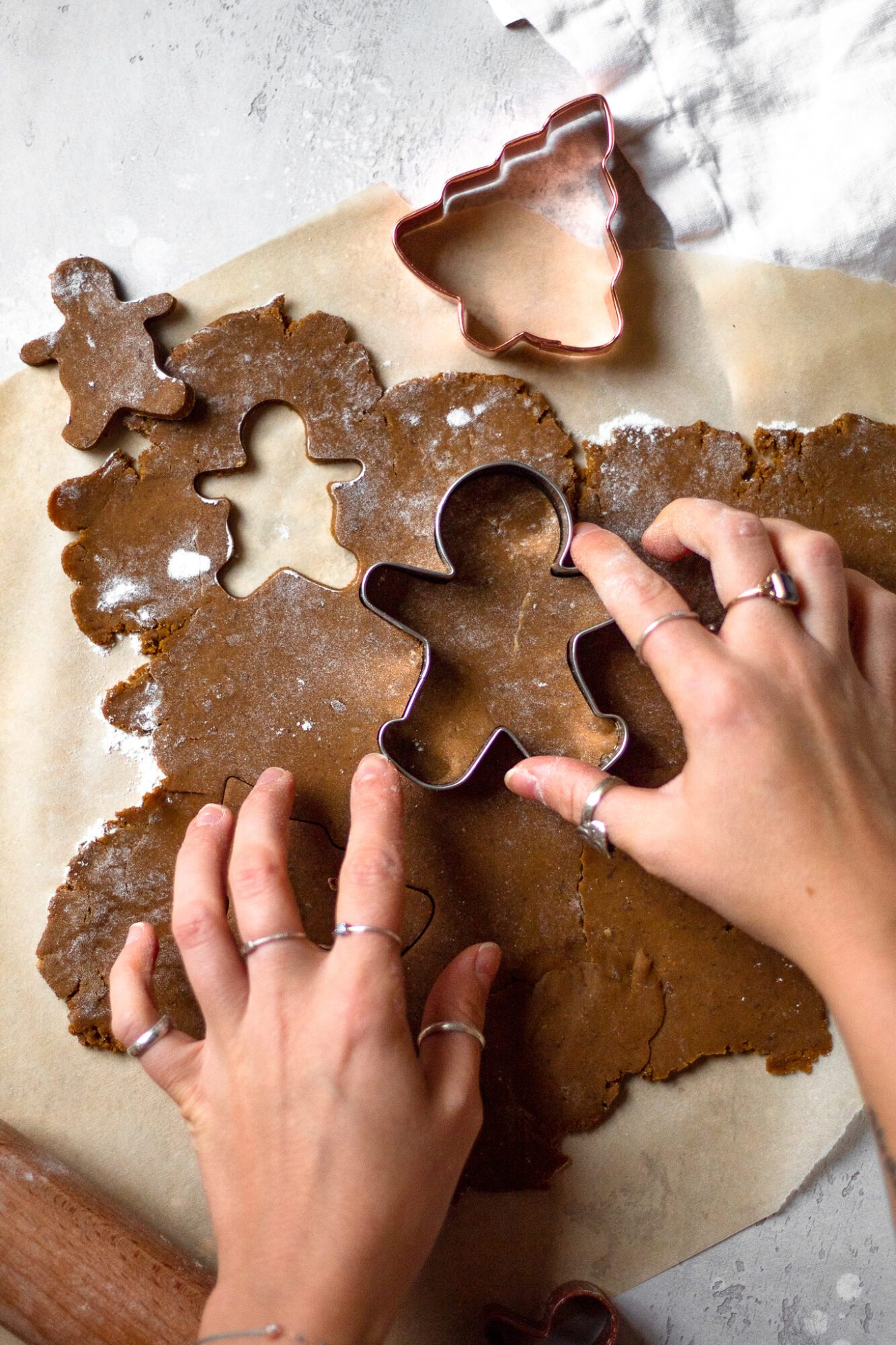 hand pressing cookie cutter into dough