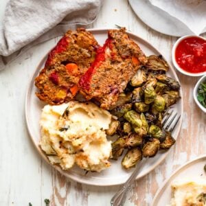 overhead of plate with lentil meatloaf, mashed potatoes, and brussels sprouts