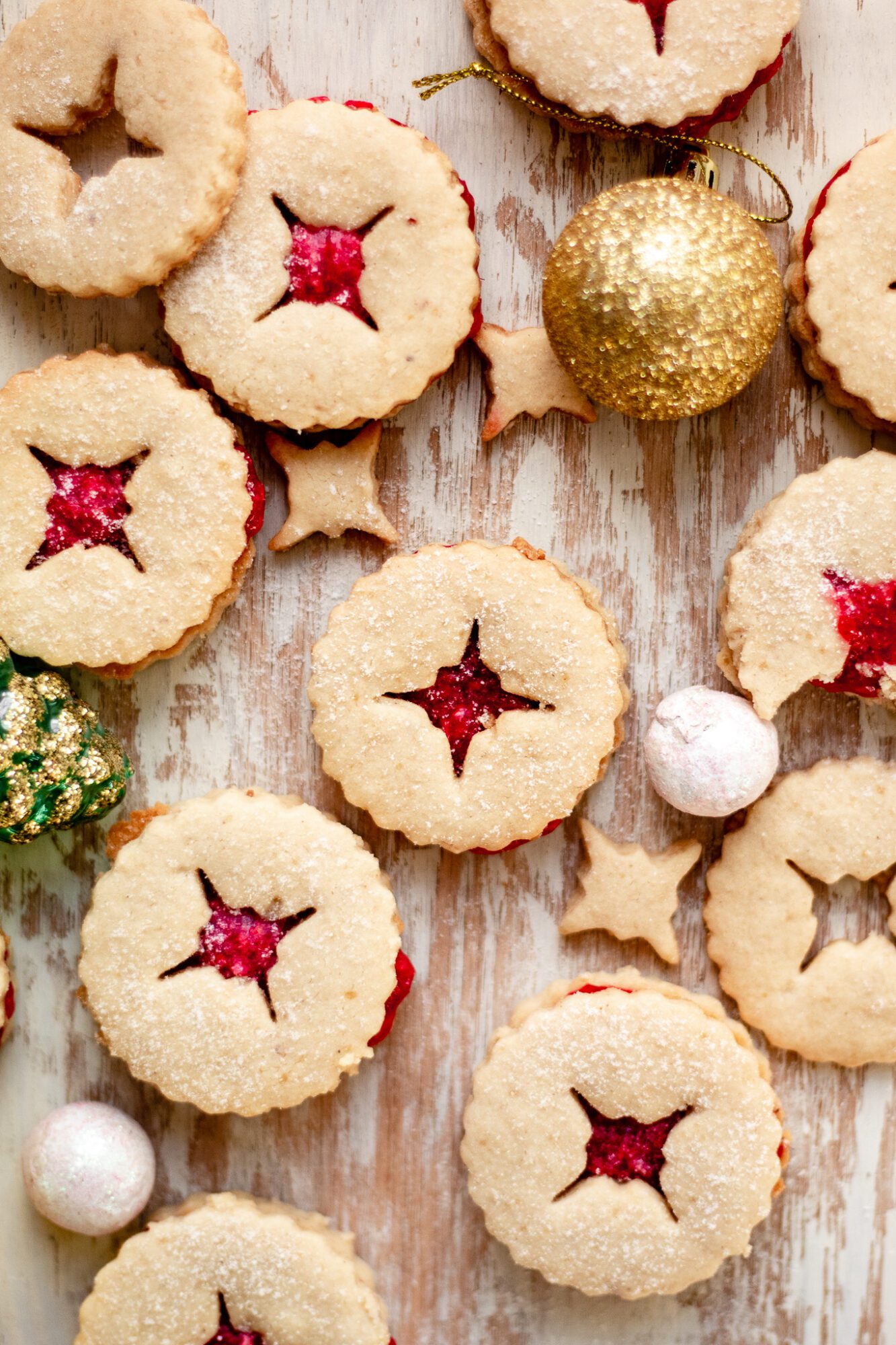 many linzer cookies on wooden board