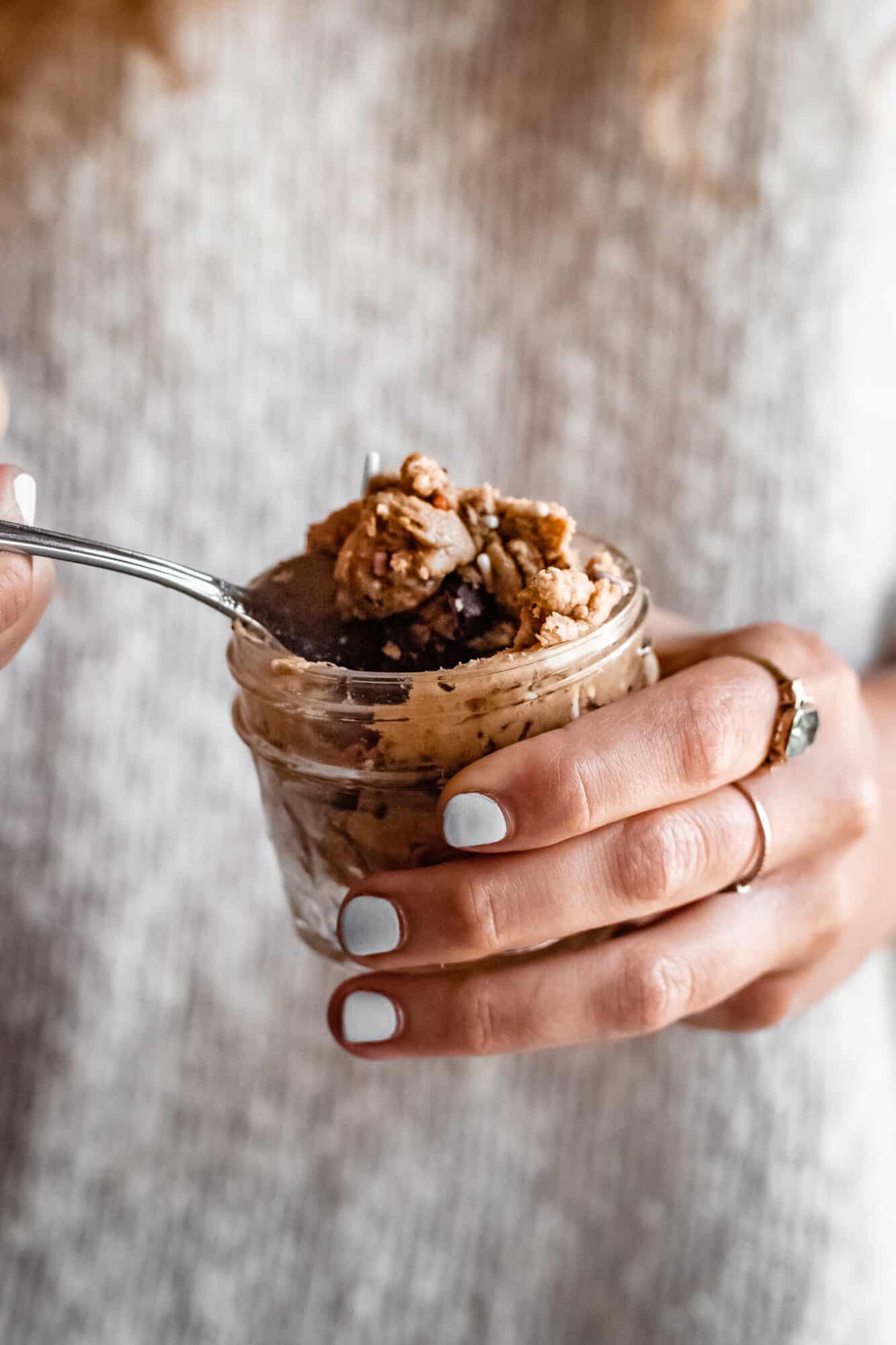 hand holding jar of protein cookie dough for one