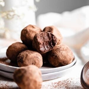 chocolate truffles with bite taken on grey plate
