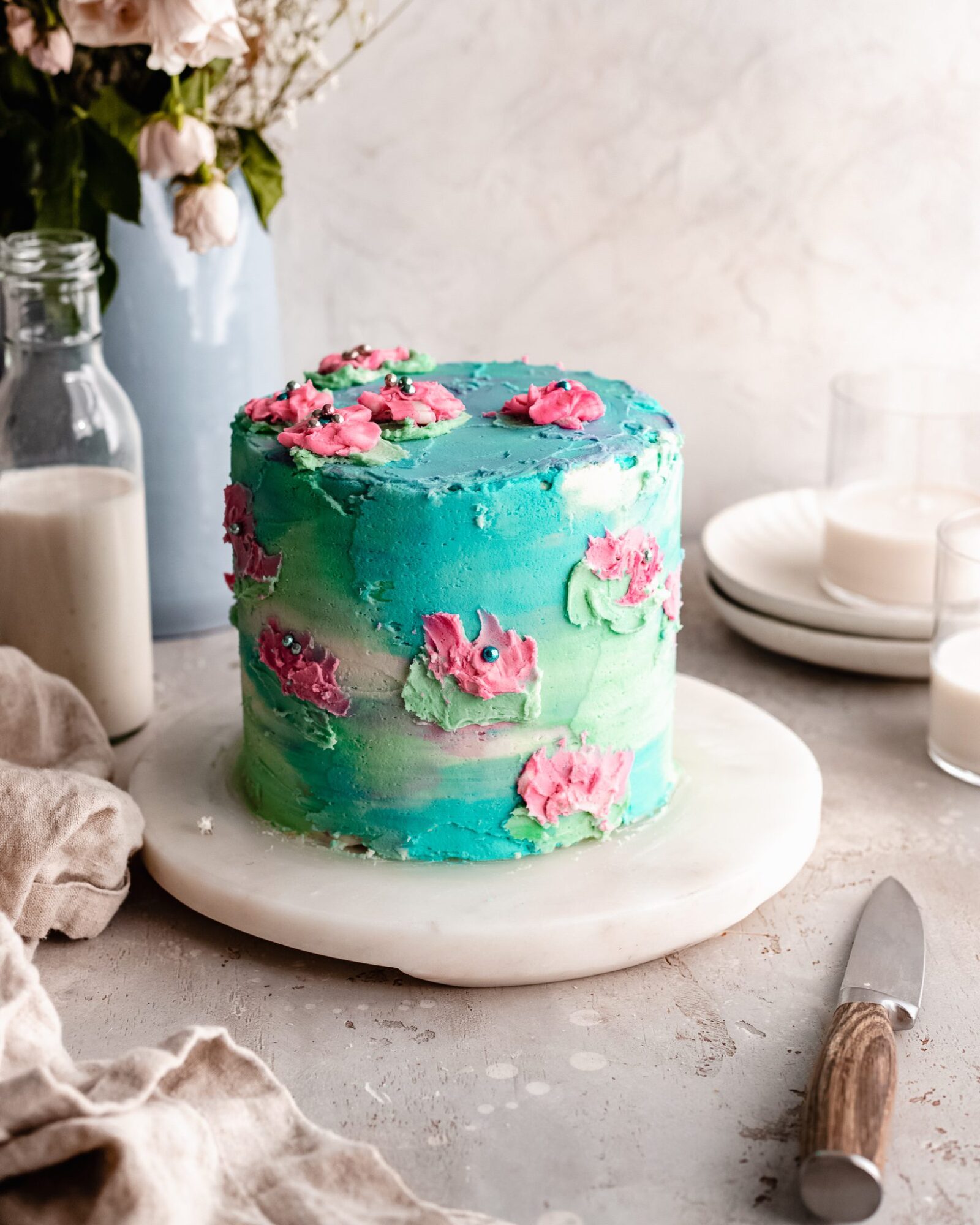 Three Tier Blue Watercolor Wedding Cake adorned with 24K Gold Leaf and  Fresh Flowers