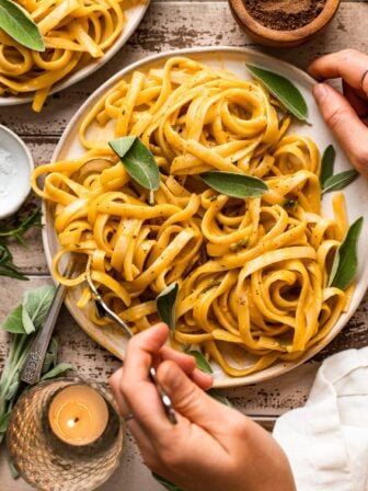 hand twirling pumpkin pasta