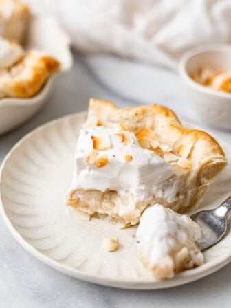 bitten slice of coconut cream pie