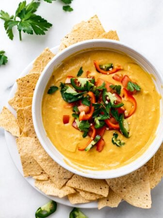 bowl of vegan Queso with toppings