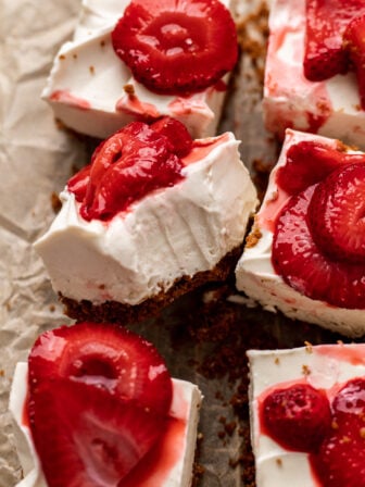 bitten vegan cheesecake bar on parchment paper