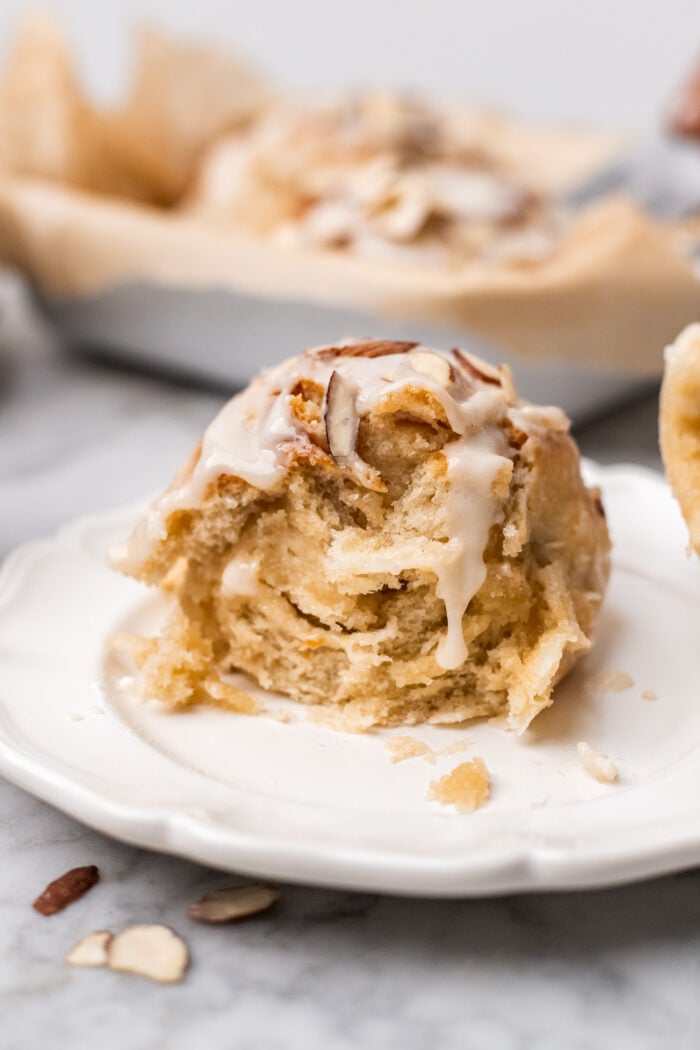 bitten vegan almond sweet roll on a plate