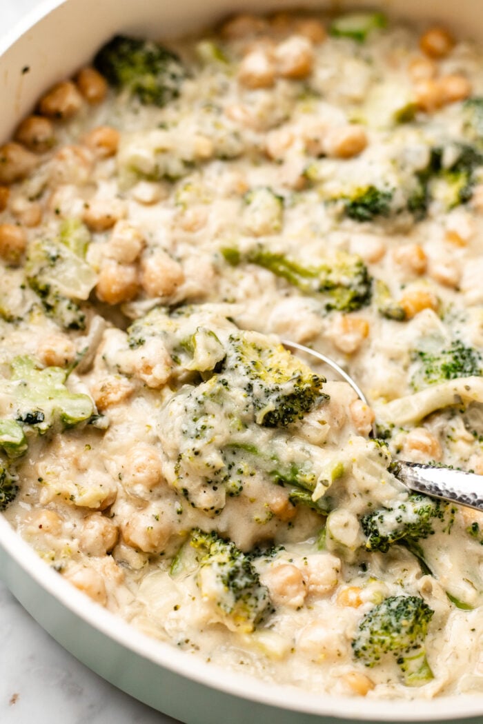 scooping the chickpea broccoli alfredo skillet