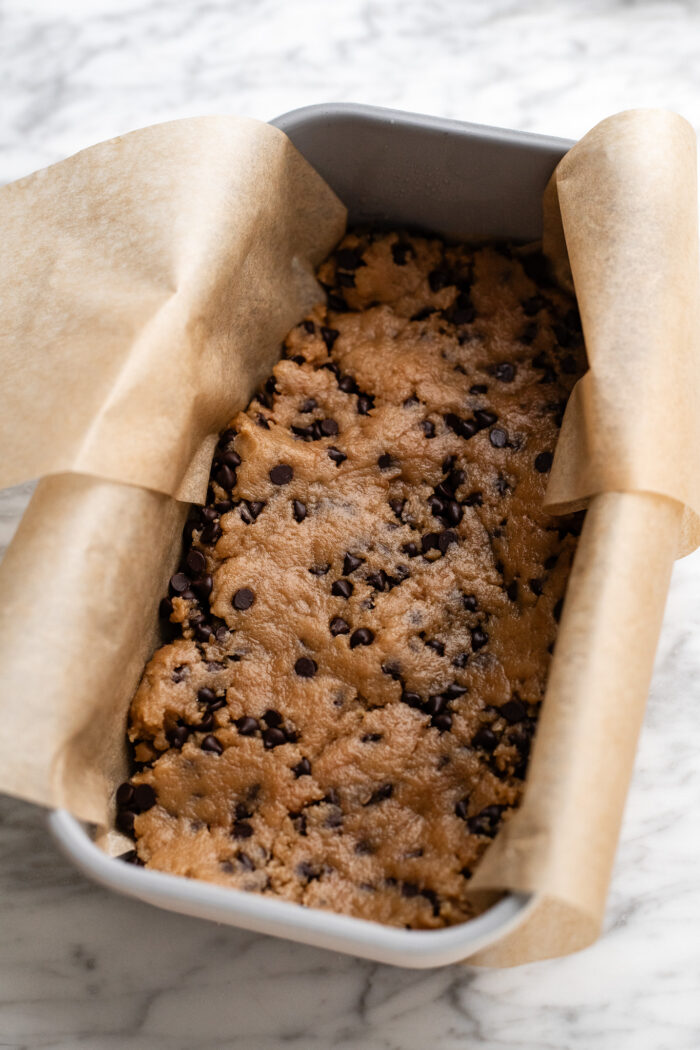 assembling the cookie dough stuffed brownies
