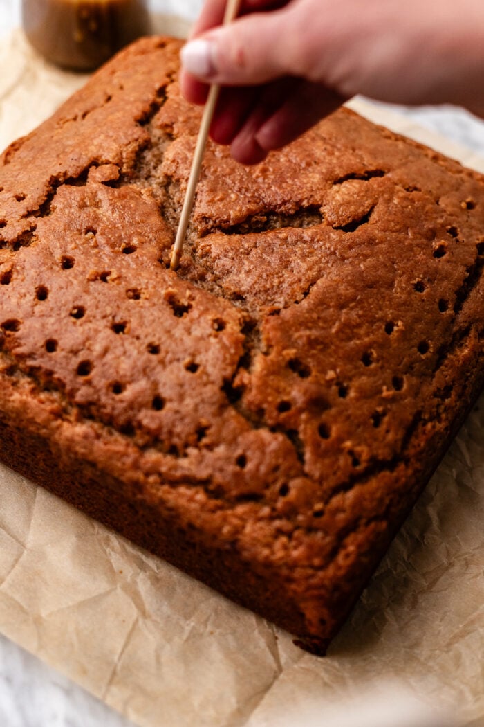 poking the cake for the toffee sauce
