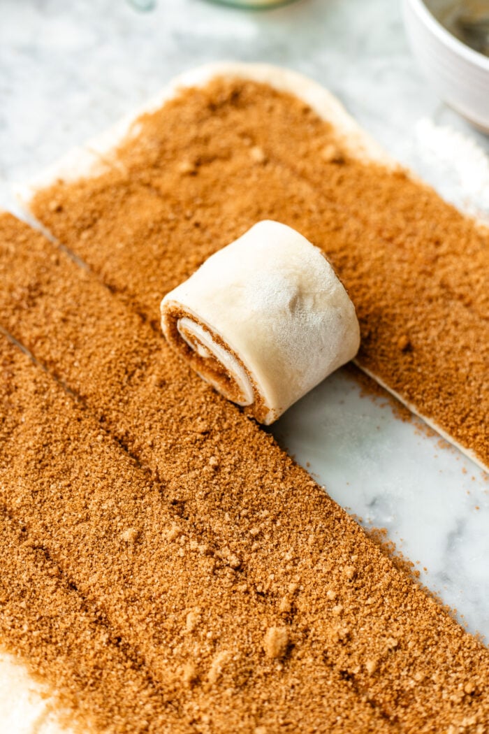 rolling the cinnamon rolls