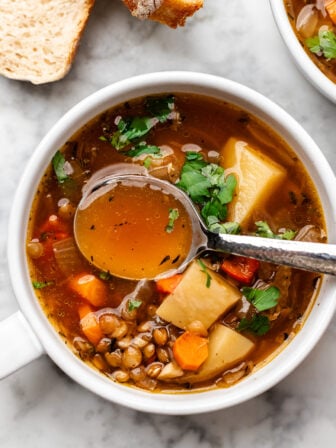 bowl of lentil potato soup with spoon