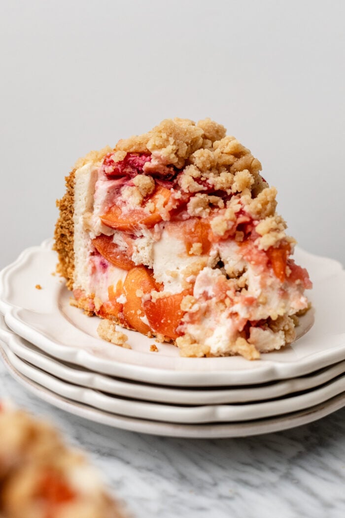 slice of peach cobbler cheesecake on a plate