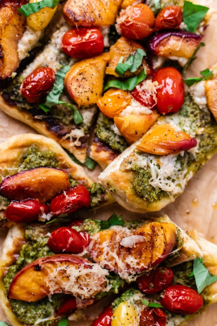 close up of vegan pizzas on parchment paper