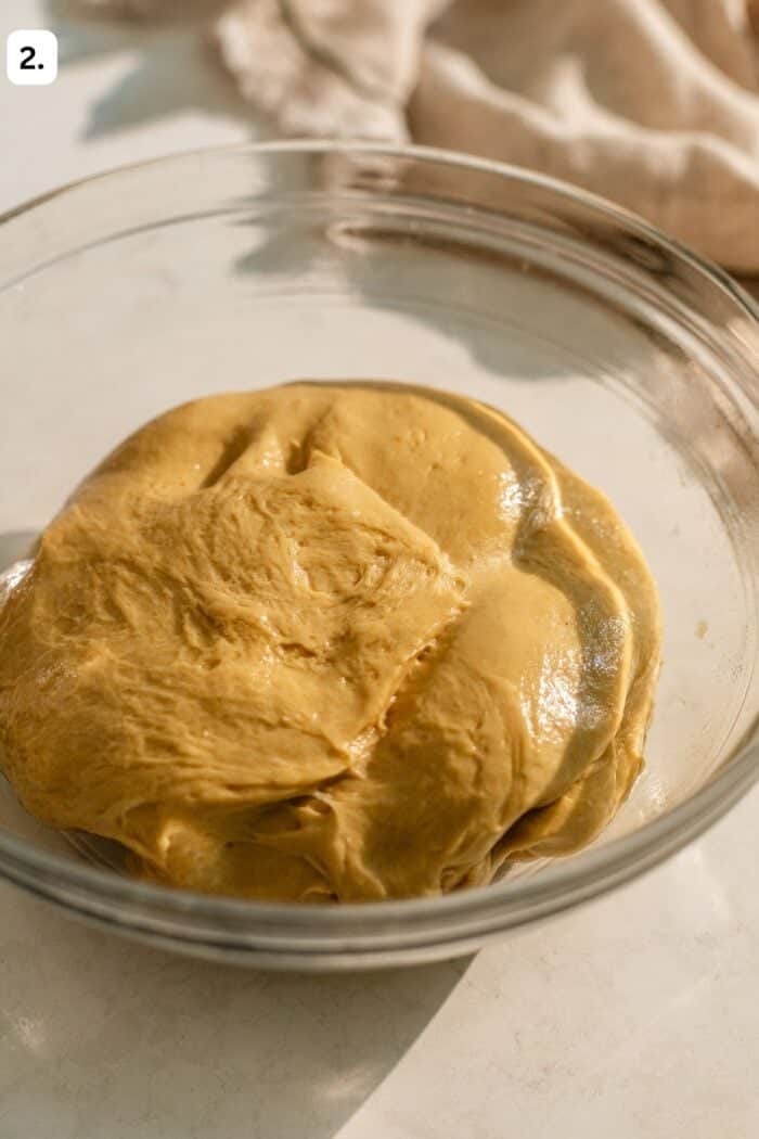 dough proofing in a bowl on the countertop.