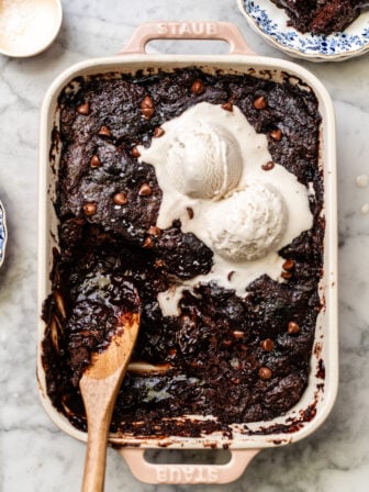 chocolate pudding cake in a casserole dish with ice cream
