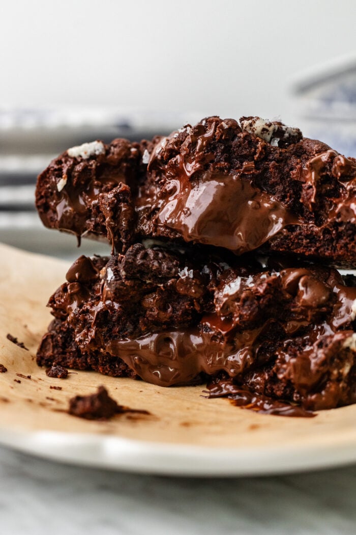 giant single serve nutella oreo double chocolate chip cookie broken in half and stacked on a plate