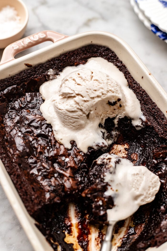 scooped out brownie pudding with ice cream and a spoon in it