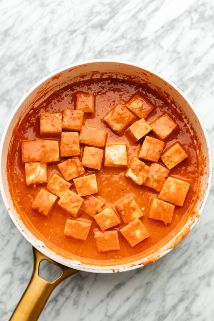 cooking the tofu in the sauce