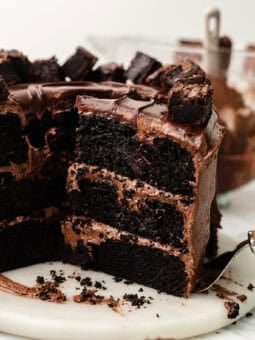 sliced vegan chocolate brownie cake on a marble platter.