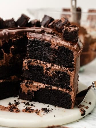 sliced vegan chocolate brownie cake on a marble platter.