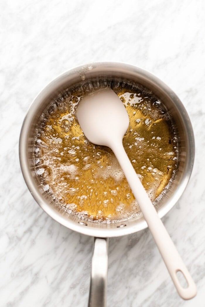 melting the sugar in a saucepan over medium heat on a marble table.