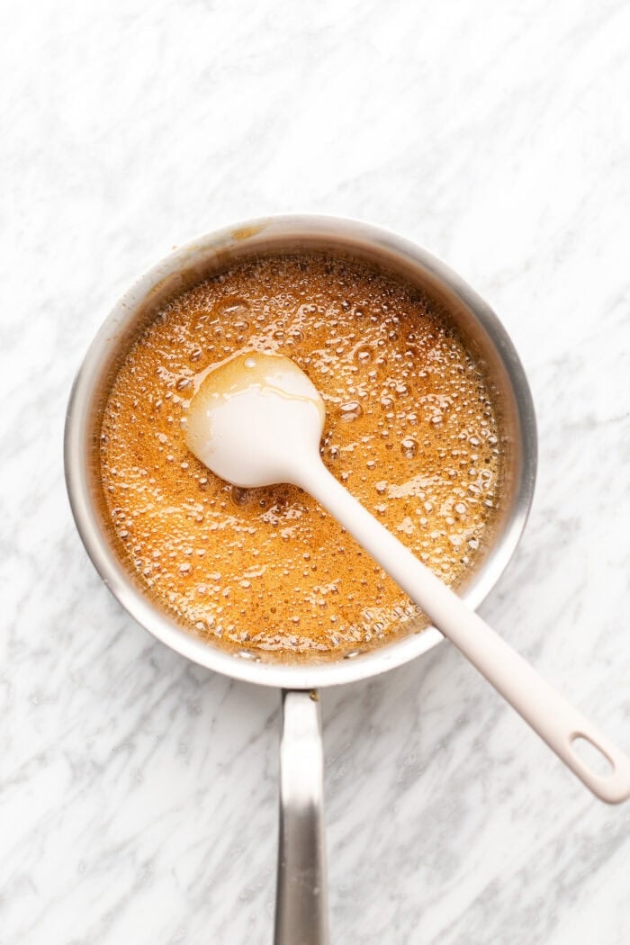caramel sugar browning before adding in the vegan butter in a saucepan over medium heat.