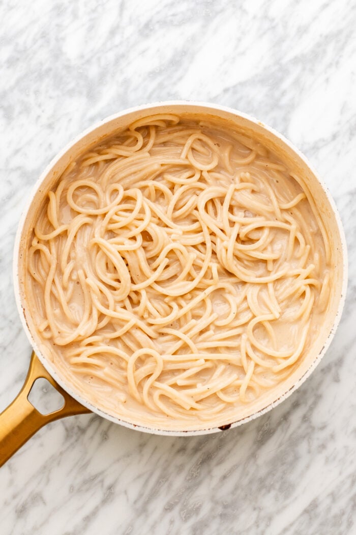 adding in the spaghetti