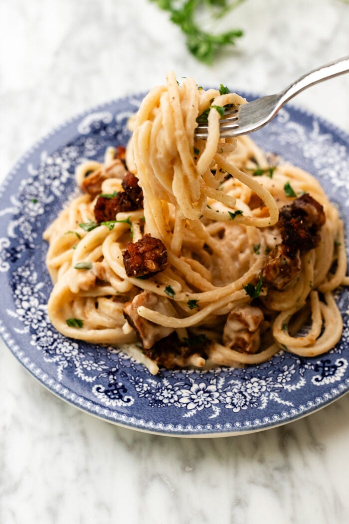 vegan carbonara pasta being eaten