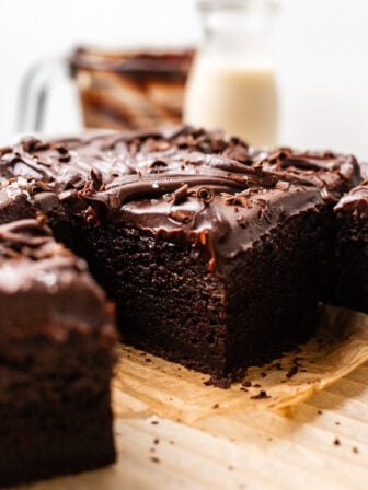One Bowl MOIST Vegan Chocolate Zucchini Cake sliced on parchment paper