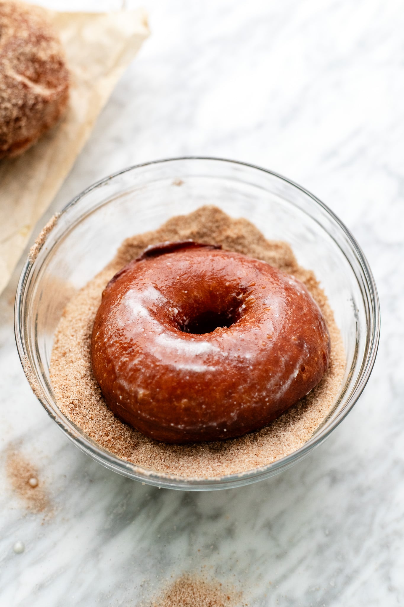 dipping the doughnuts in sugar