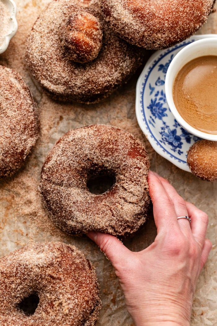 hand grabbing sugar doughnut