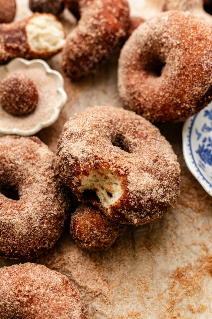 bitten sugar doughnut with coffee