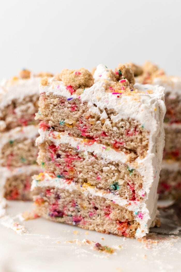 sliced vegan funfetti cake on marble plate