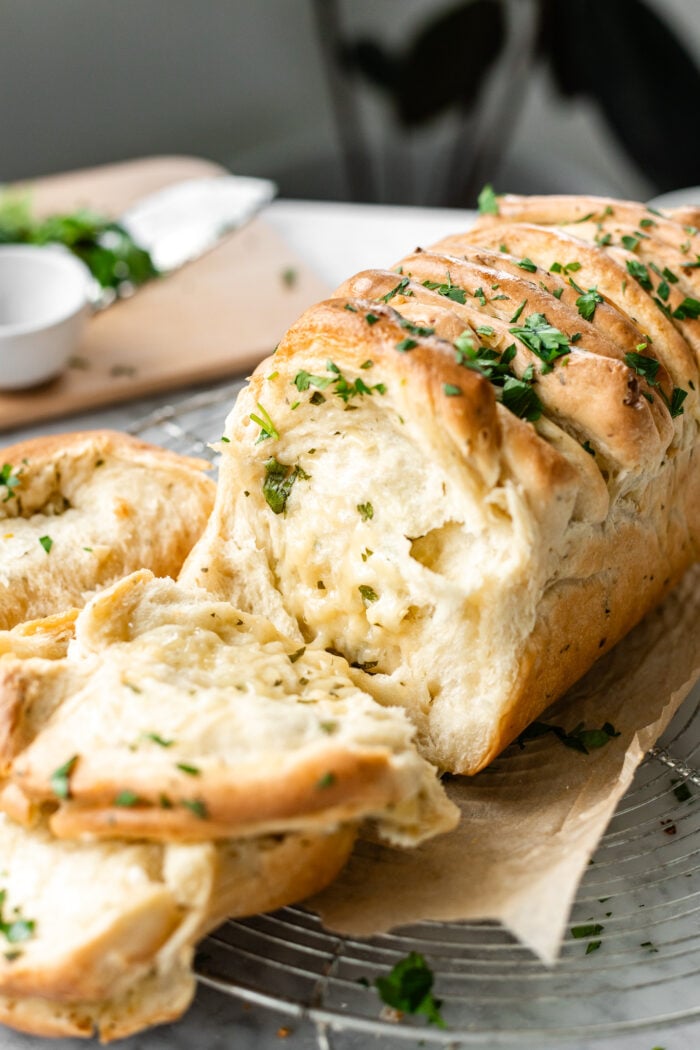 pulled apart garlic bread on cooling rack