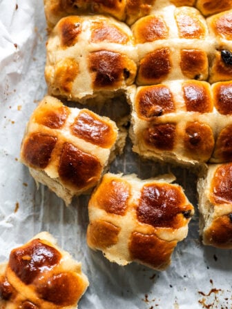 vegan hot cross buns on parchment paper