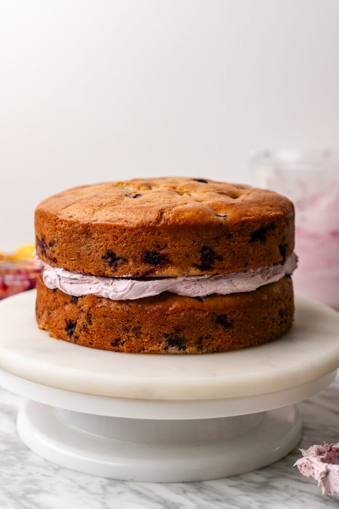 assembling vegan lemon blueberry cake