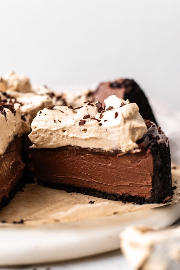 sliced vegan no bake chocolate cheesecake on a cake plate