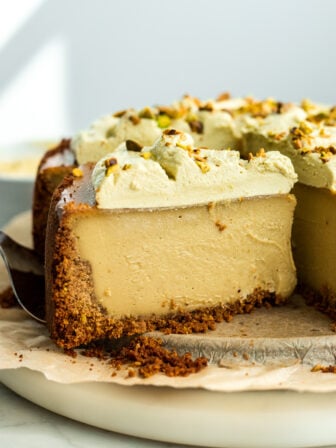sliced vegan pistachio cheesecake on a plate