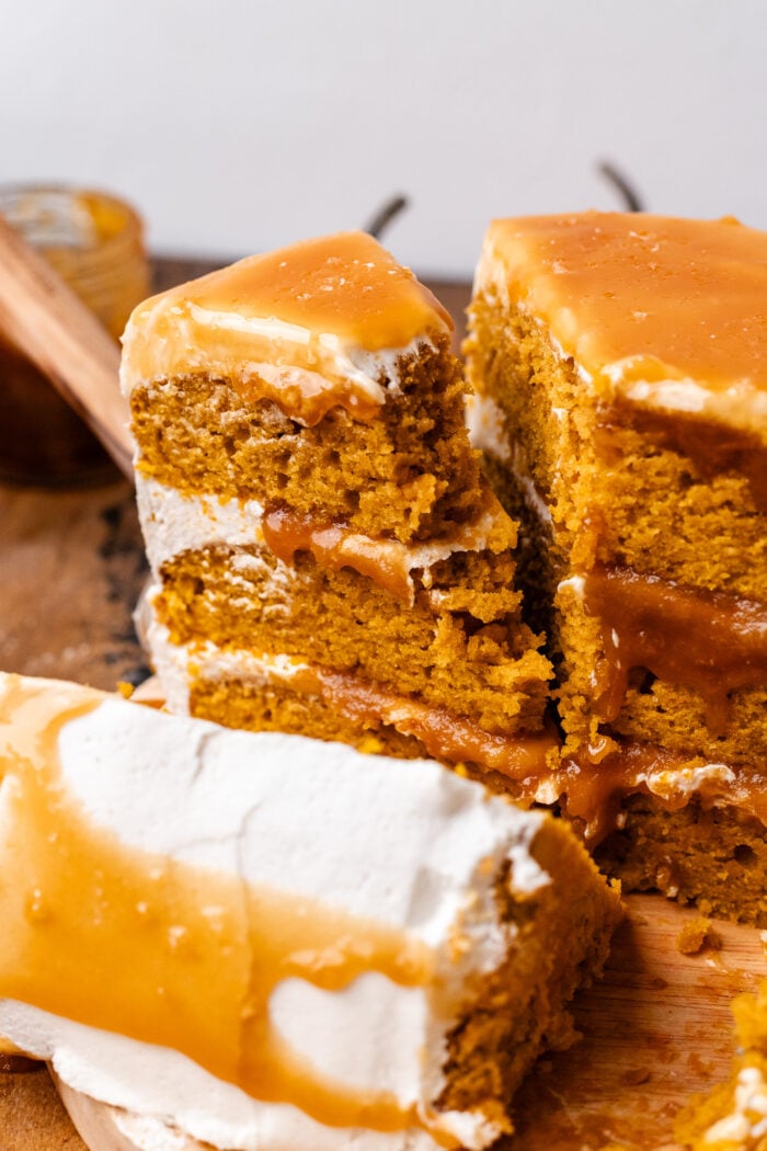 bitten slice of vegan pumpkin cake with caramel sauce