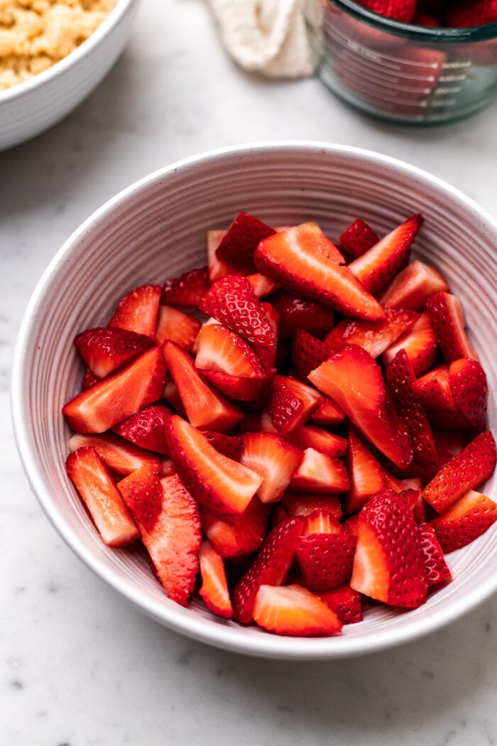 bowl of sliced strawberries for strawberry crumb cake