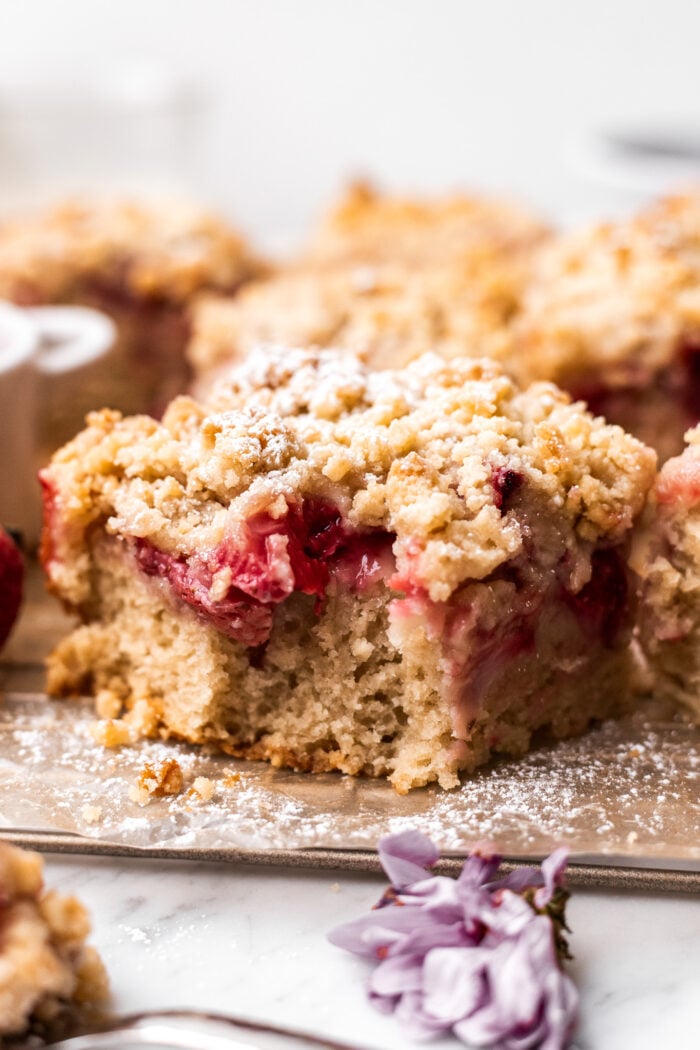 bitten slice of strawberry crumb cake