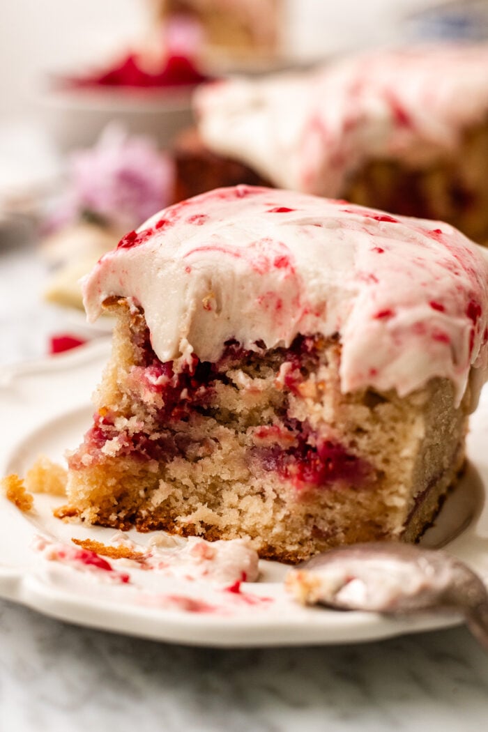 bitten slice of white chocolate raspberry cake